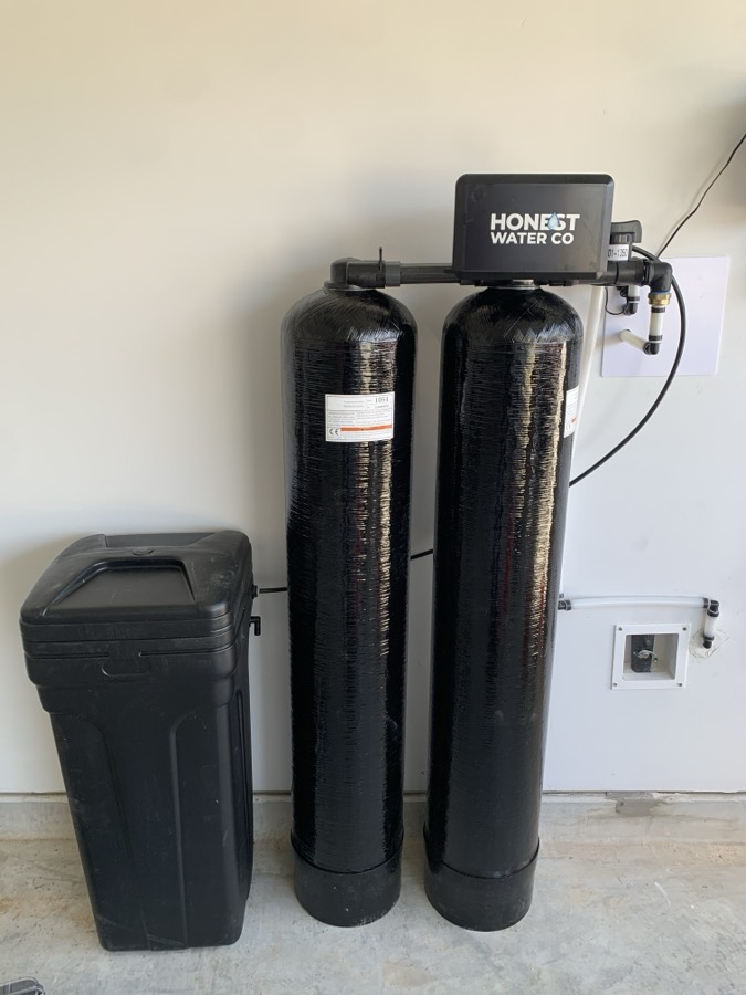 Whole-home water filtration system installed in a garage