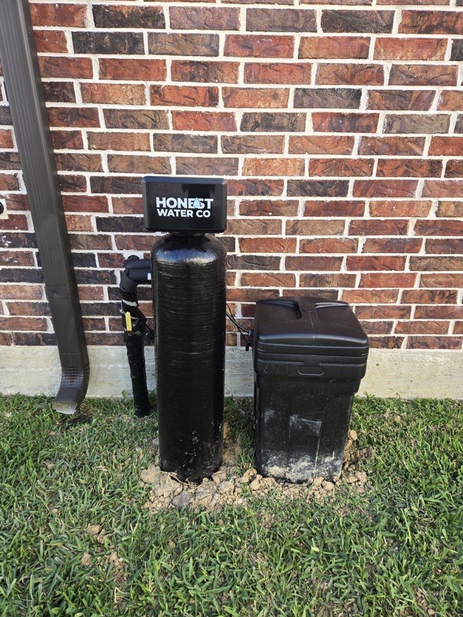 Water softener system with digital valve installed in a garage